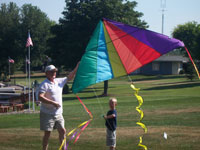 Fernandina Beach back pain free grandpa and grandson playing with a kite